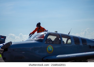 Surabaya, Indonesia - June 12, 2022: A Woman Navy Pilot And The Beechcraft Bonanza Plane On The Apron Of A Military Air Base