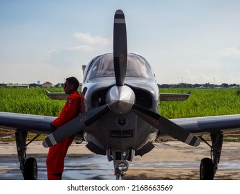 Surabaya, Indonesia - June 12, 2022: A Navy Pilot Poses In Front Of The Beechcraft Bonanza Plane On The Apron Of A Military Air Base