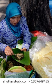 Surabaya, Indonesia.
March 2, 2014.

The Woman Selling Semanggi Pecel, A Typical Surabaya Food Made From Cloverleafs Is Preparing Food For Buyers.