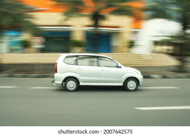 SURABAYA, INDONESIA - May 01, 2011: A Silver Family Car From Japanese Brand Moving Fast In Front Of Mall In Surabaya