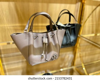 Surabaya, Indonesia - May, 2022 : Fashion Shop Window With Female Handbags And Shoes Display. Fashion Green, Black Handbag Display On Shelf. Yellow Handbag Display On Shelf. Shop Window.