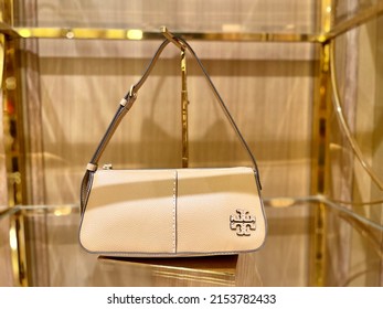 Surabaya, Indonesia - May, 2022 : Fashion Shop Window With Female Handbags And Shoes Display. Fashion Green, Black Handbag Display On Shelf. Yellow Handbag Display On Shelf. Shop Window.