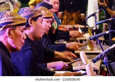 Surabaya, Indonesia - May 31, 2022: Men in traditional Javanese costumes are playing Gamelan, a famous traditional Javanese music instrument.