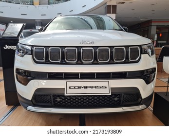 Surabaya, Indonesia on June 29, 2022 : Jeep Compass is a compact crossover SUV. All wheel drive hybrid car is parked on showroom