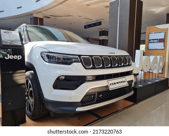 Surabaya, Indonesia on June 29, 2022 : Jeep Compass is a compact crossover SUV. All wheel drive hybrid car is parked on showroom