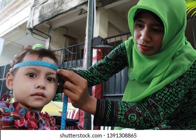 Surabaya-Indonesia, October 28, 2013. Health Workers Are Measuring The Child's Head Circumference In A Community Health Center.