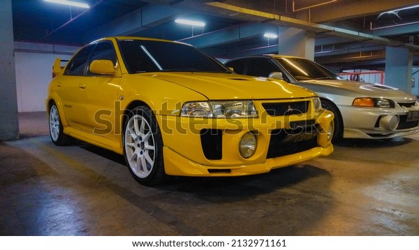 Surakarta Indonesia February\
27 2022 yellow Mitsubishi Lancer Evolution V in an underground\
parking lot
