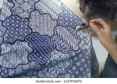 SURAKARTA INDONESIA, JUNE 17 2018 : Close Up Hand Painting Batik On The Blue Fabric. Batik Tulis