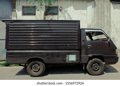 Surakarta, Indonesia - November 08 2019: Vintage Picture Of Old And Dusty Classic Pickup Car Parking On The Side Of The Road In The Afternoon 