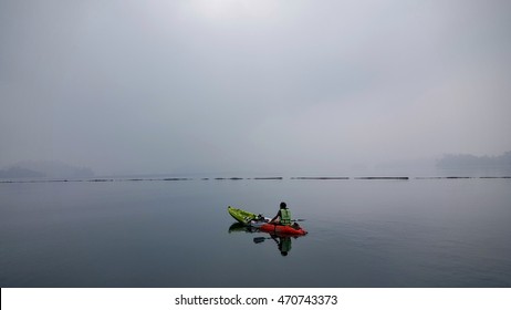 SURATTANI, THAILAND, 8 OCT 2016 : One Old Man Kayaking On The Big And Quiet Lake In Surattani, South Of Thailand, In Early Morning Of Cloudy Day By Alone