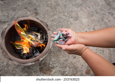 SURATTHANI, THAILAND - FEBRUARY 18 : People burns fake money for ancestor beliefs of the Chinese people in Chinese New Year on February 18, 2015 in Suratthani, Thailand.
