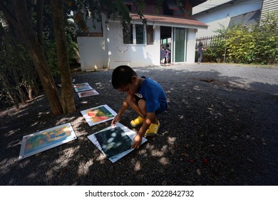 SURATTHANI, THAILAND - OCTOBER 30, 2017:  Asian Boy With His Painting Art Work  At Home, Home Schooler And Waldorf Education Concept.