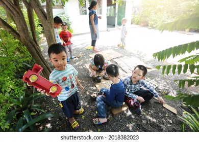 SURATTHANI, THAILAND - OCTOBER 30, 2017:Group Of Little  
 Asian Kids Playing With Wooden Toys In Garden,home Schooler And Waldorf Education Concept.