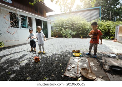 SURATTHANI, THAILAND - OCTOBER 30, 2017:Group Of Little  
 Asian Kids Playing With Wooden Toys In Garden,home Schooler And Waldorf Education Concept.