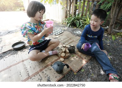 SURATTHANI, THAILAND - OCTOBER 30, 2017:Little  
 Asian Boy And Girl Playing With Wooden Toys In Garden,home Schooler And Waldorf Education Concept.