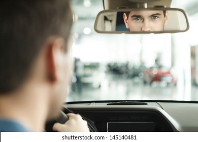 I Am Sure With My Car Choise. Hansome Young Men Sitting At Front Seat Of The Car Looking At Review Mirror