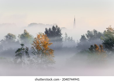 a sureal misty landscape in Flanders with a view towards the church of Tielrode.