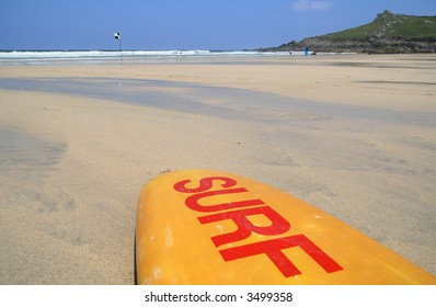 A Surf Board On The Beach, St. Ives, Cornwall.