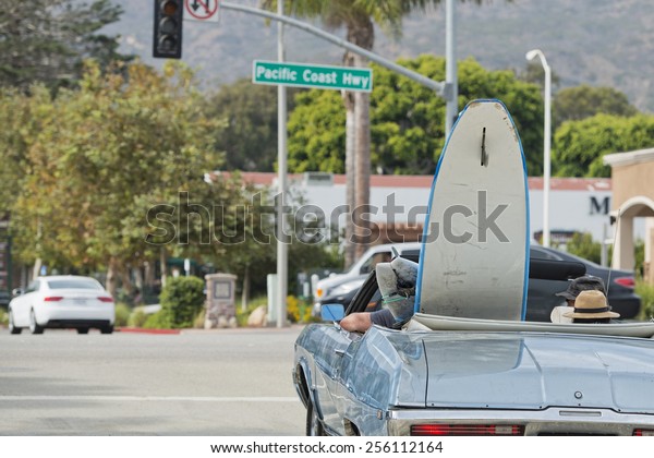 surf board in a\
vintage car in California