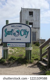 Surf City, North Carolina / United States - April 30, 2017: Welcome Sign and Operation Bumblebee Tower