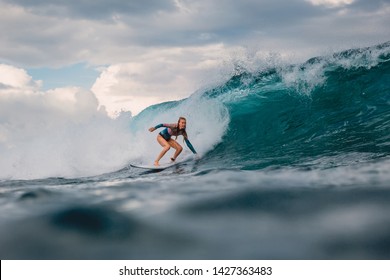 Surf Girl On Surfboard. Surfer Woman And Big Blue Wave