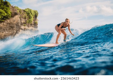 Surf girl on surfboard. Woman in ocean during surfing. Surfer on longboard and ocean wave - Powered by Shutterstock