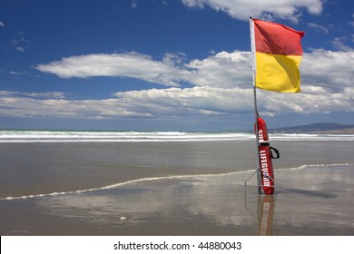 Surf Lifesaving Flag And Buoyancy Aid On A New Zealand Beach