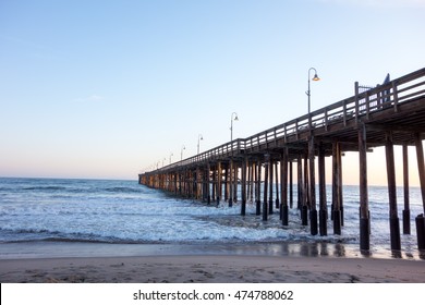 Surf waves near historic wooden pier in city of San Buena Ventura, Southern California