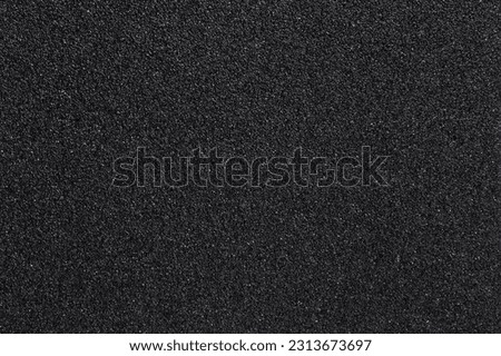 Surface black sandpaper texture. Close up of of skateboard grip tape