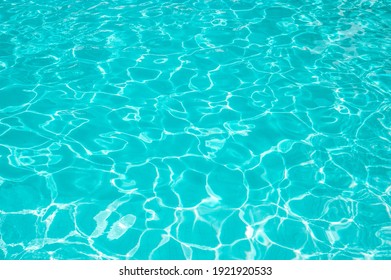 Surface of blue swimming pool. Summer background. Texture of water surface