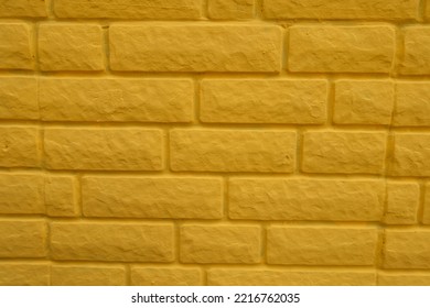 Surface Of Bright Yellow Painted Brick Veneer Wall