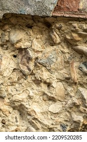 The Surface Of A Building Material Consisting Of Cobblestones In A Concrete Mixture.