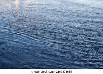 The surface of clear water in a river as an abstract background. View at blue smooth surface of the river, water surface - Shutterstock ID 2167876655