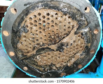 The surface of the condenser or the heat exchanger with copper tube, there is sediment or sludge on the surface. Maintenance concept.