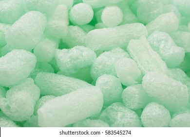 Surface covered with the multiple bioplastic packing foam peanuts as an abstract backdrop composition