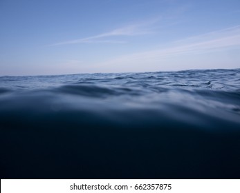 Surface Of Dark Deep Blue Ocean With Current, Give Feeling Scary, Fear And Danger From Bottom Of The Sea.