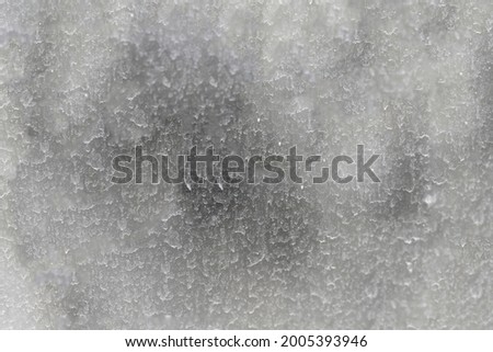 The surface of the dirty window glass, covered with dusty traces of raindrops. Blurred abstract texture.