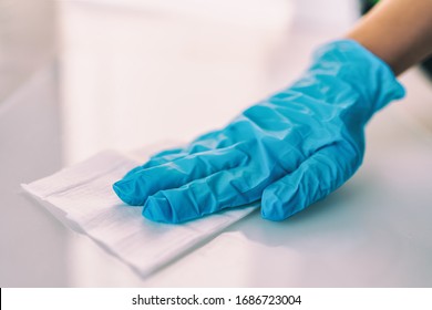 Surface Disinfecting Home Cleaning With Sanitizing Antibacterial Wipes Protection Against COVID-19 Spreading Wearing Medical Blue Gloves. Sanitize Surfaces Prevention In Hospitals And Public Spaces.