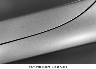 Surface of gray sport sedan, car bodywork, detail of metal fender and hood of modern vehicle, automobile industry, selective focus