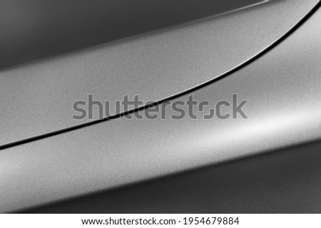 Surface of gray sport sedan, car bodywork, detail of metal fender and hood of modern vehicle, automobile industry, selective focus
