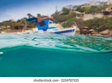 Surface level of boat moored at harbor and waves moving in blue sea against mountain - Shutterstock ID 2224787325