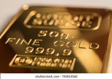 The Surface Of Minted Gold Bar Weighing 50 Grams. The Texture Of The Surface Of The Gold Ingot.