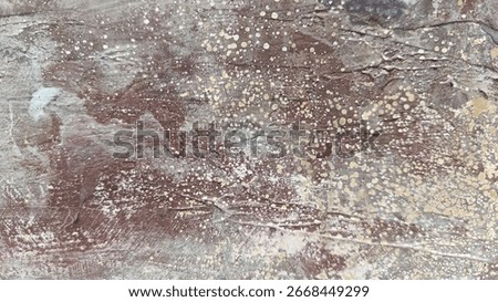 A surface with multiple layers of paint, revealing different colors and a rough, mottled texture.