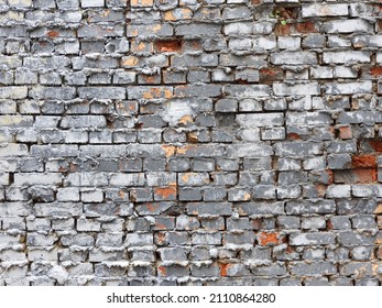 The surface of an old brick wall with potholes and crevices. Close-up, Abstract background.
					