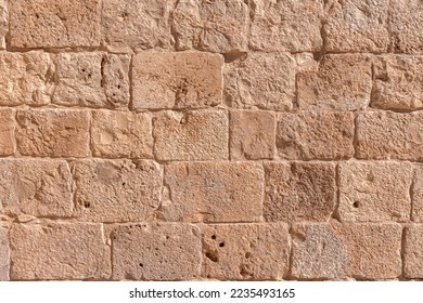 Surface of old wall made of the Jerusalem stone. Israel