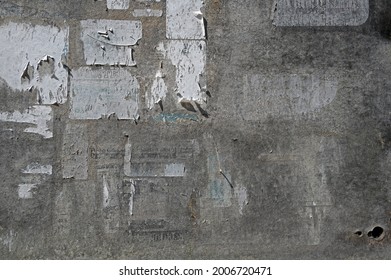 Surface of an old weathered bulletin board with remnants of torn paper ads, abstract grunge background texture, copy space - Powered by Shutterstock