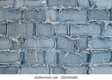 Surface Of Pieces Of Old Tattered Denim Closeup
