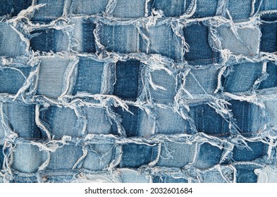 Surface Of Pieces Of Old Tattered Denim Closeup
