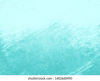 The surface of the plastered wall is rough, uneven, and green with a sloppy look. Artistic and abstract background.