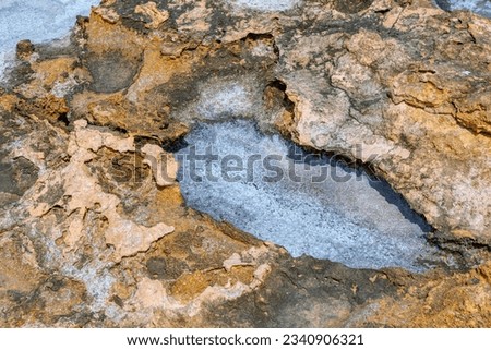 Surface of the rock in the geothermal area . Natural salt on the stone 